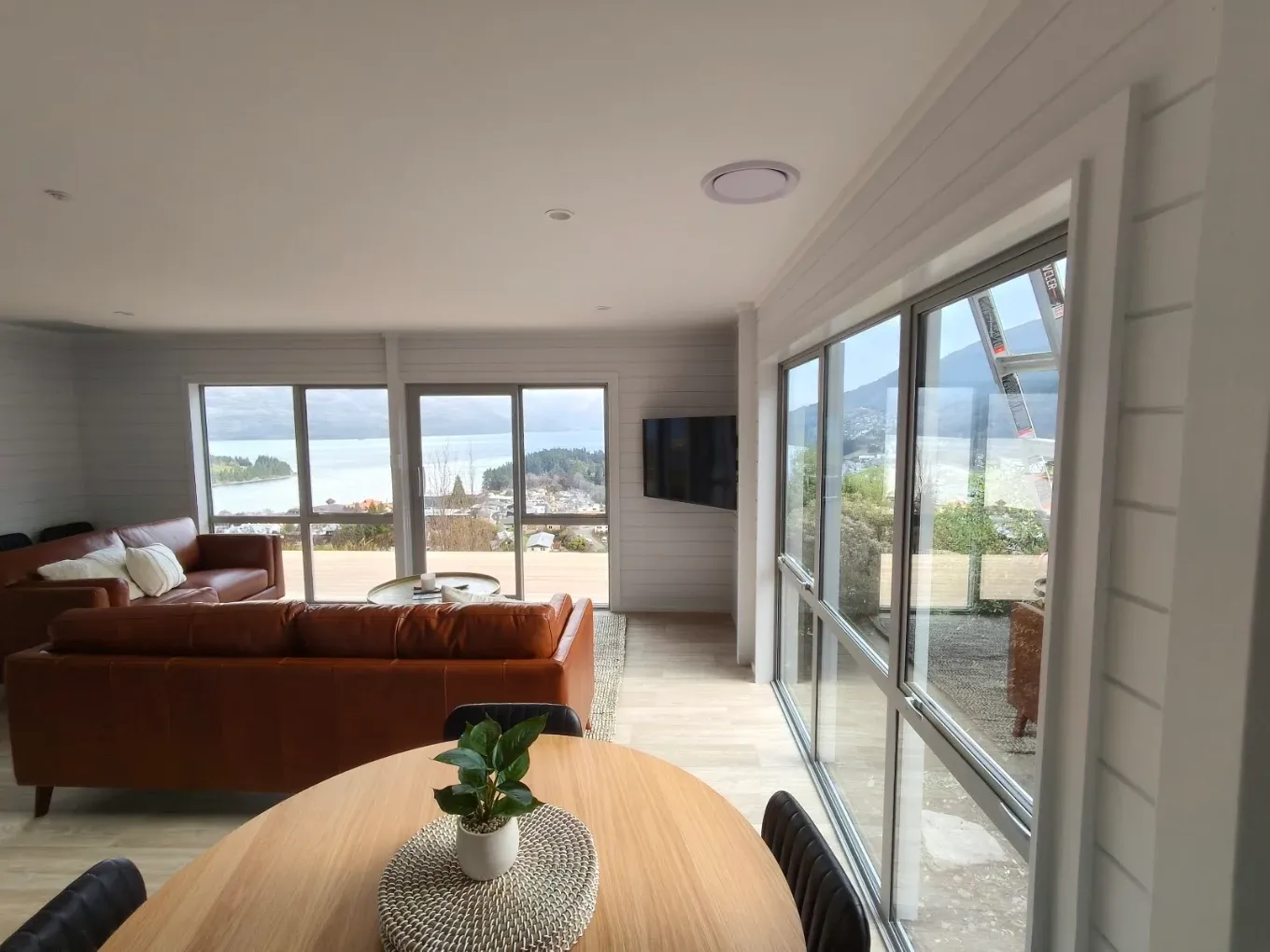 Open plan dining and living space with lake view