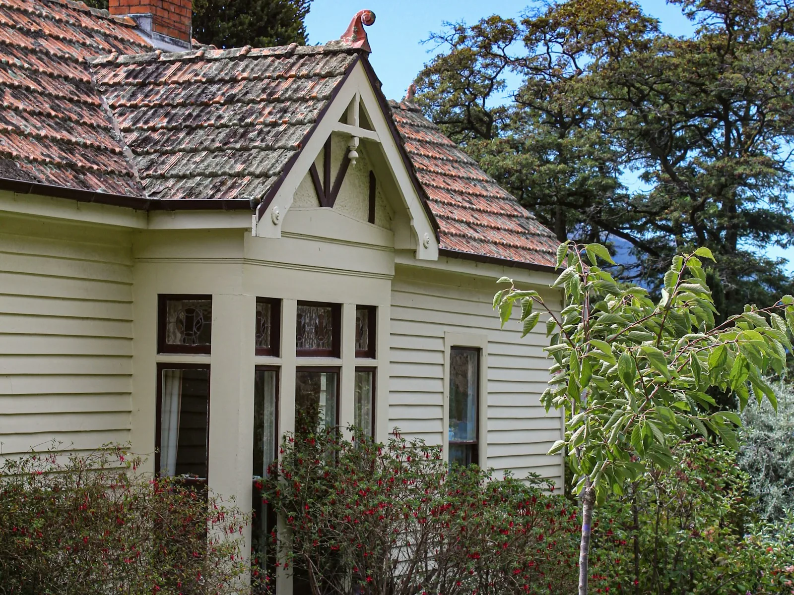 White weatherboard cottage exterior with a tiled roof