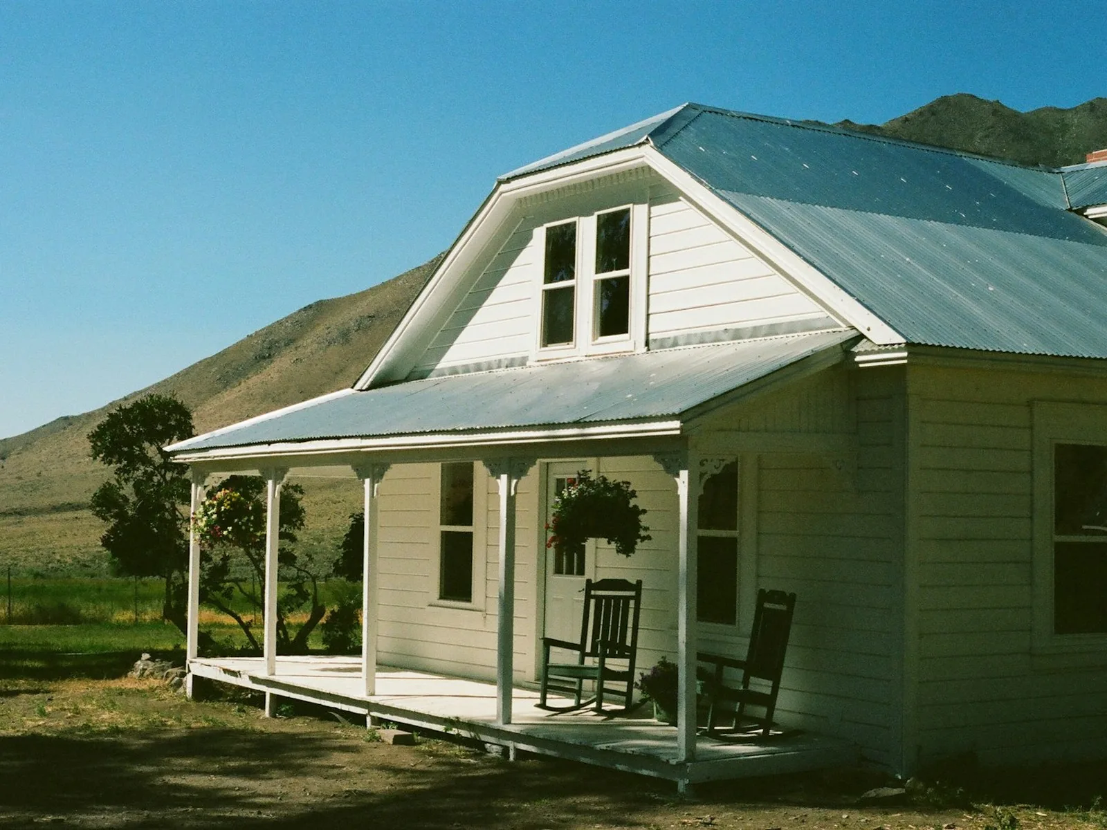 White weatherboard farmhouse exterior repaint