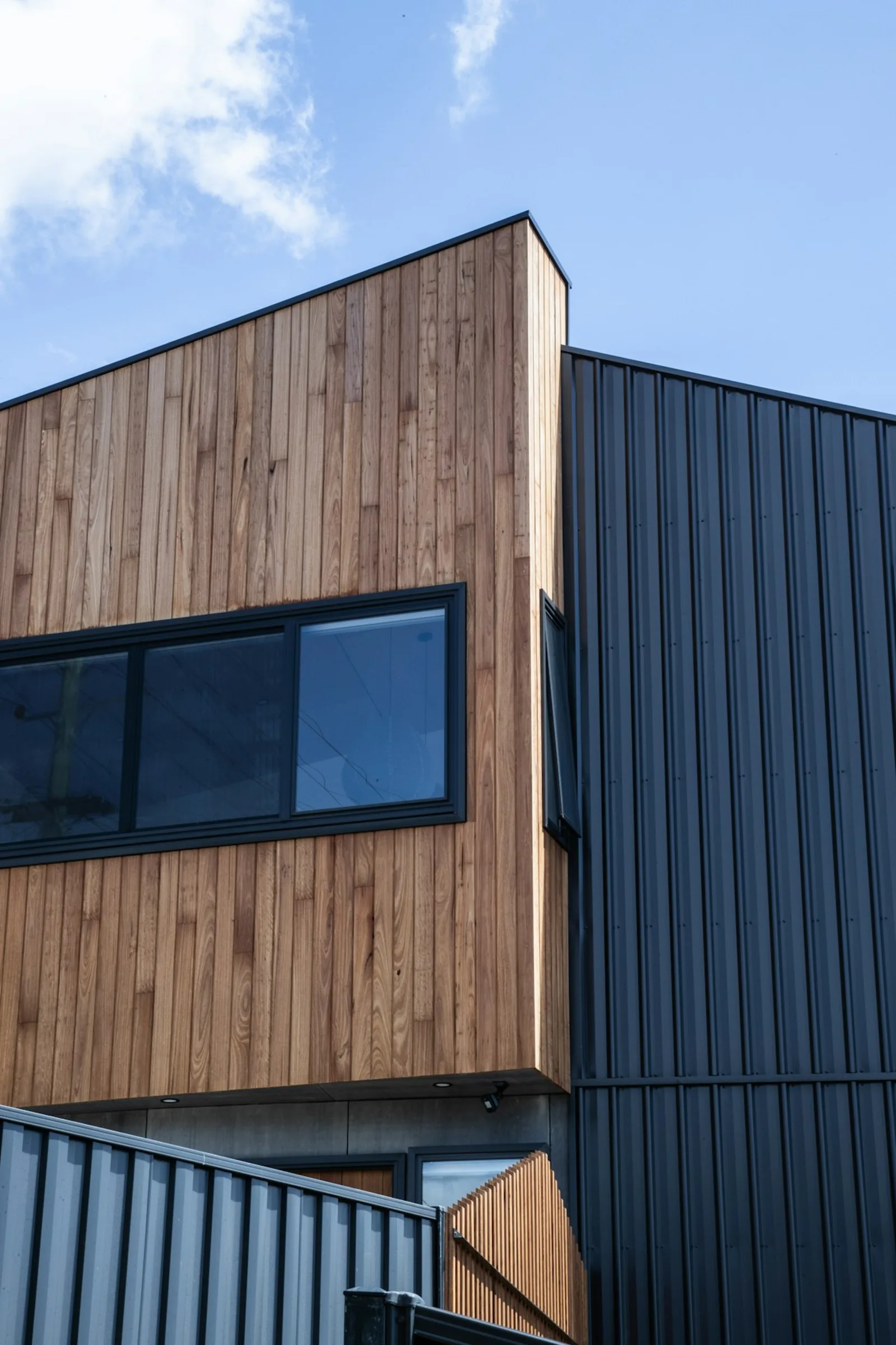 Stained cedar alongside painted dark cladding